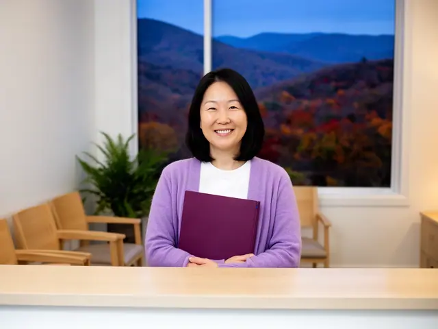 A clinic office manager holding a folder behind a reception counter.